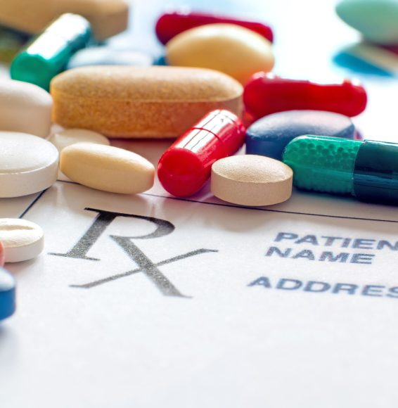 Close up photo of prescription pills with prescription paper